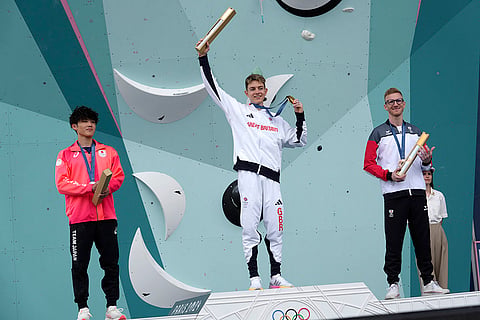Men's boulder and lead final: Gold medallist Toby Roberts of Great Britain, center, silver medallist Sorato Anraku of Japan, left, and bronze medallist Jakob Schubert of Austria
